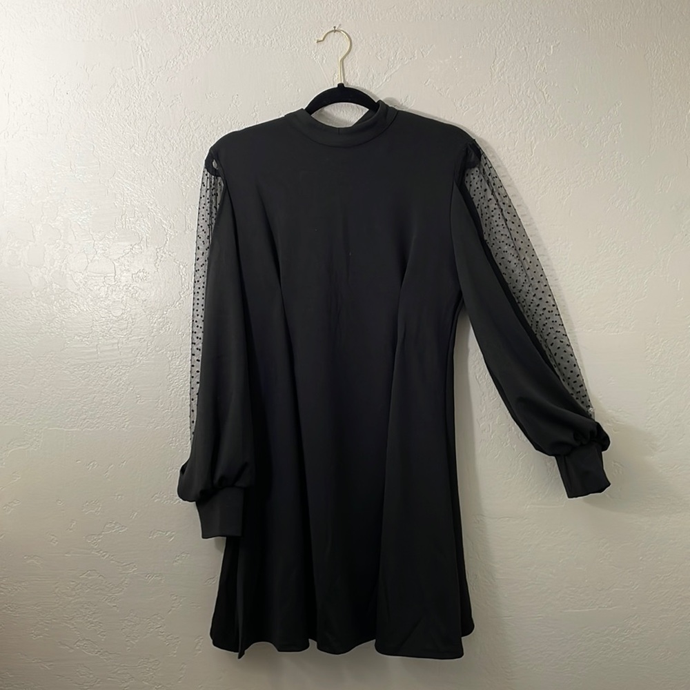 M MIDI Black dress with pleats in the front and peekaboo polka dot long sleeves.
